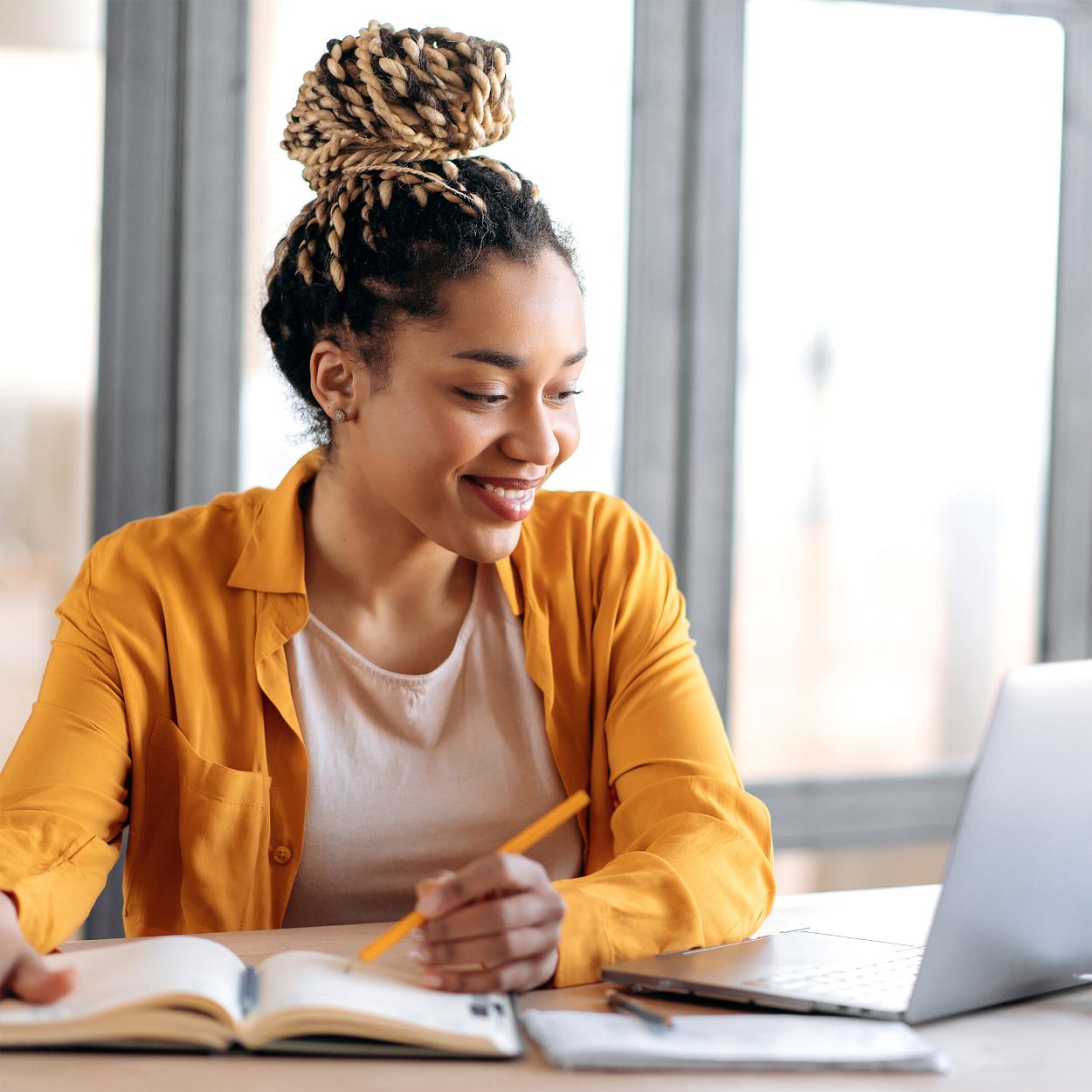 Woman accountant at desk writing notes