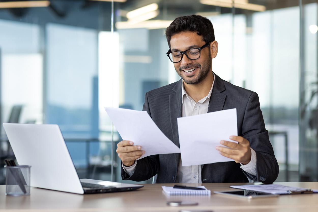 Man in office reading documents